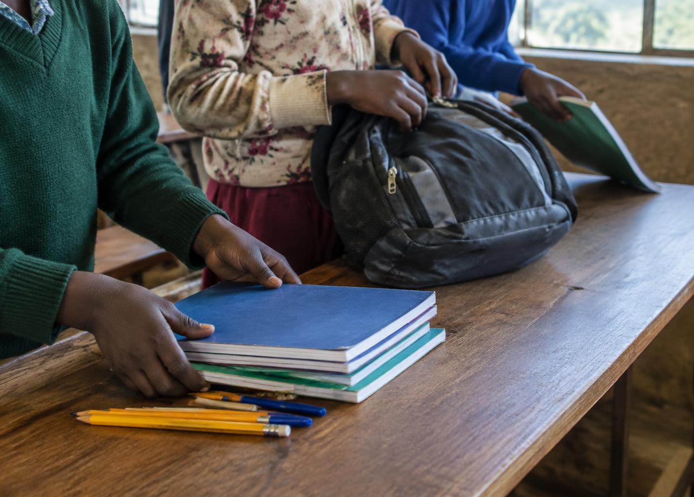 School supplies being arranged on a desk